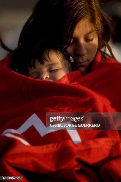 Children rest wrapped on a Red Cross blanket in the streets of Lorca, southern Spain, on May 12, 2011 after a magnitude 5.2 quake killed at least 8...