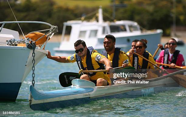 James Marshall and Victor Vito of the Hurricanes push away from a moored boat as they compete in a Wakaama challenge during the 2013 Super Rugby...