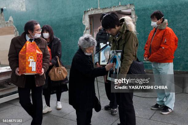Japan-disaster-tsunami-crematorium FOCUS by John Saeki In a picture taken on March 25, 2011 the grandmother of deceased brothers 16-year-old Itaru...