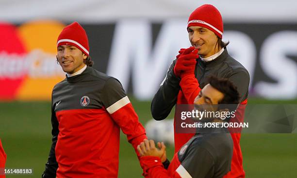 Paris Saint-Germain's Swedish forward Zlatan Ibrahimovic and PSG's Brazilian defender Maxwell react during a training session at the Mestalla stadium...