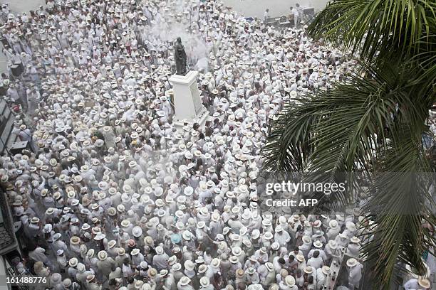 People throw talcum powder at one another as they take part in the carnival of "Los Indianos" in Santa Cruz de la Palma, on the Spanish Canary island...