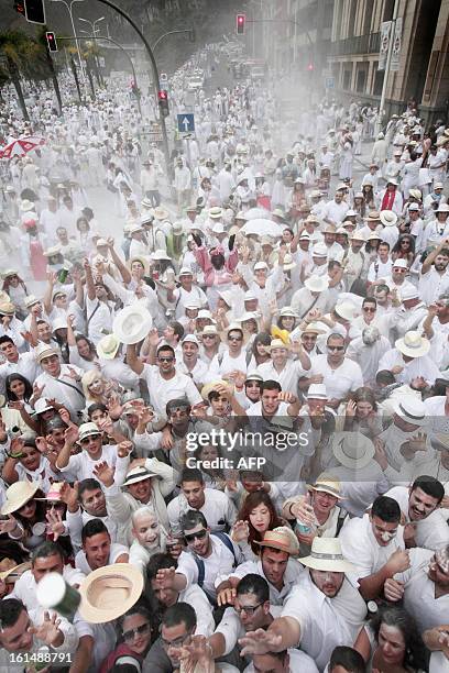 People throw talcum powder at one another as they take part in the carnival of "Los Indianos" in Santa Cruz de la Palma, on the Spanish Canary island...