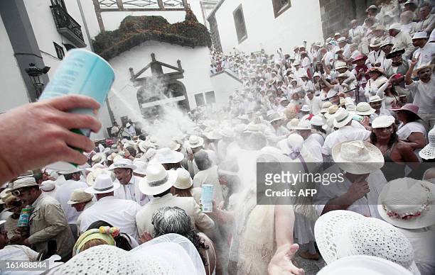 People throw talcum powder at one another as they take part in the carnival of "Los Indianos" in Santa Cruz de la Palma, on the Spanish Canary island...