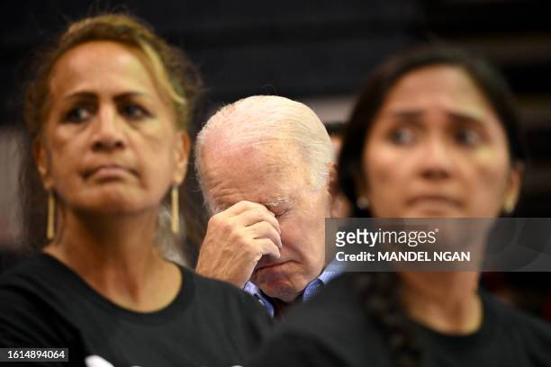 President Joe Biden looks down as he listens to a speaker during a community engagement event at the Lahaina Civic Center in Lahaina, Hawaii on...