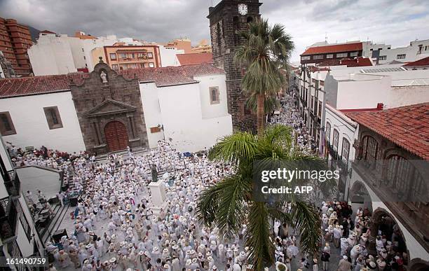 People throw talcum powder at one another as they take part in the carnival of "Los Indianos" in Santa Cruz de la Palma, on the Spanish Canary island...