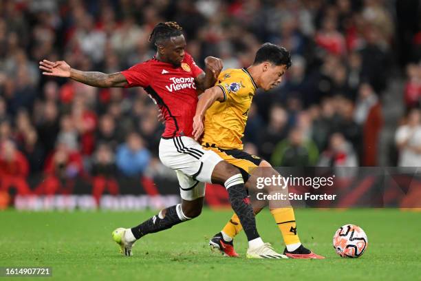 Hwang Hee-Chan of Wolverhampton Wanderers is fouled by Aaron Wan-Bissaka of Manchester United during the Premier League match between Manchester...