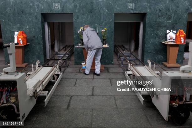 Japan-disaster-tsunami-crematorium FOCUS by John Saeki In a picture taken on March 25, 2011 a crematorium employee prepares for the cremation of...