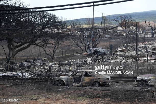 Fire damage is seen from US President Joe Biden's motorcade in Lahaina, Hawaii, on August 21, 2023. The Bidens are expected to meet with first...