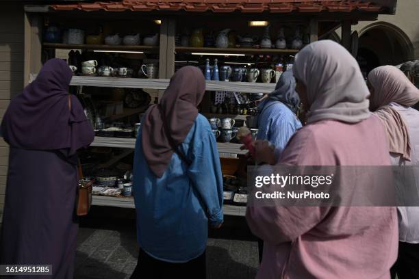 Group of tourists from the Middle East seen in Krakow's Market Square, on August 13 in Krakow, Lesser Poland Voivodeship, Poland.