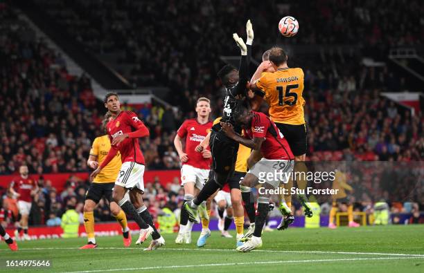 Manchester United goalkeeper Andre Onana challenges Wolves defender Craig Dawson which goes to VAR for a penalty check during the Premier League...