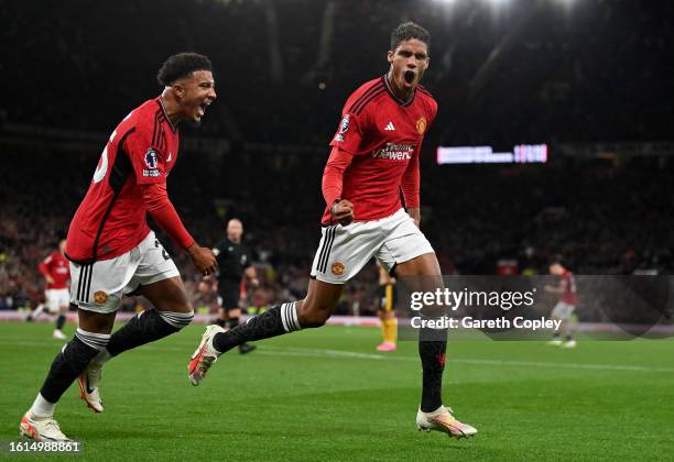 Raphael Varane of Manchester United celebrates with Jadon Sancho after scoring the team's first goal during the Premier League match between...