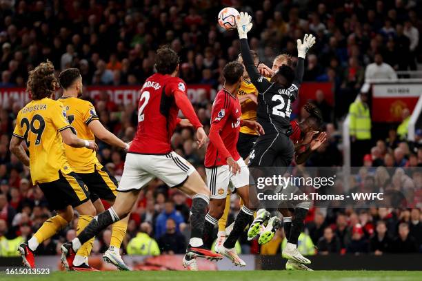 Andre Onana of Manchester United collides with Sasa Kalajdzic of Wolverhampton Wanderers during the Premier League match between Manchester United...