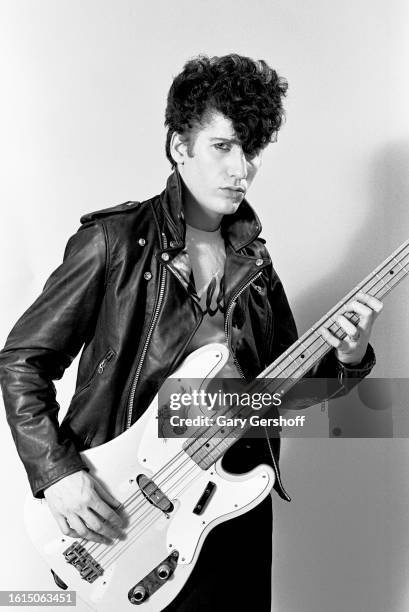 Portrait of American Rockabilly musician Lee Rocker , of the group Stray Cats, as he poses with a bass guitar, Long Island, New York, June 15, 1984.