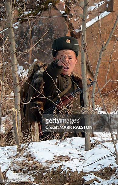 North Korean soldier reacts as he patrols along the Yalu River near the North Korean town of Sinuiju after the country conducted it's third nuclear...