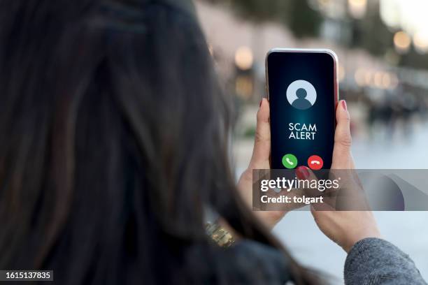scam alert on mobile phone screen - suspicion stock pictures, royalty-free photos & images
