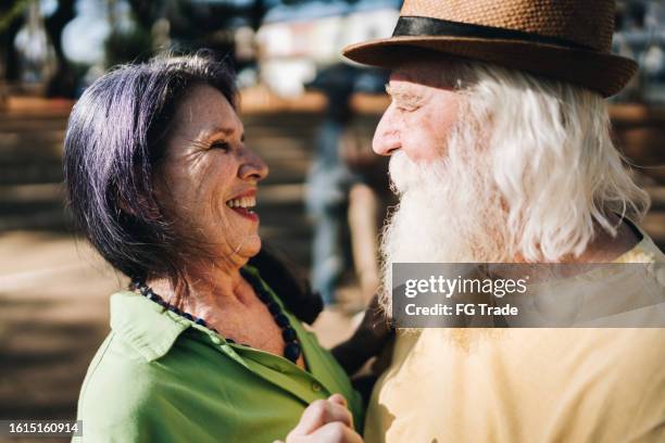 senior couple dancing in the park - danse de salon photos et images de collection