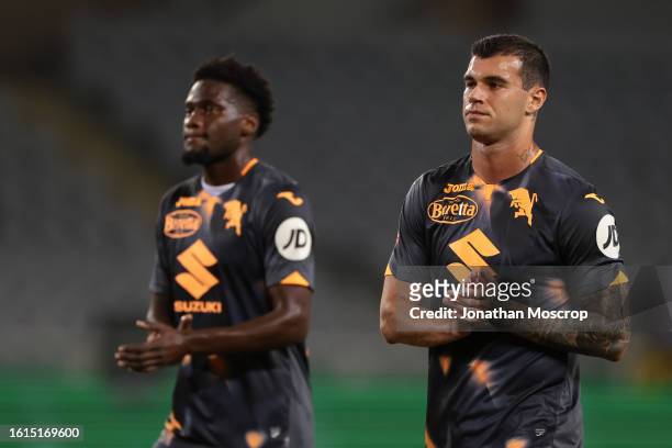 Pietro Pellegri and Brian Bayeye of Torino FC applaud the fans following the final whistle of the Coppa Italia Round of 32 match between Torino FC...