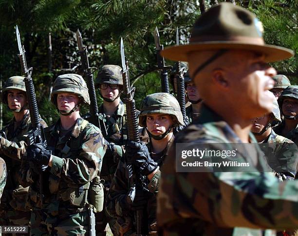 Soldiers taking part in the U.S. Army's infantry basic training listen to the drill sergeant before a bayonet drill November 7, 2002 at Ft. Benning,...