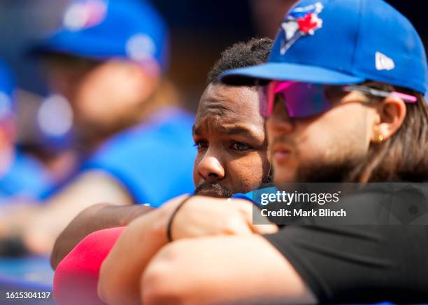 Vladimir Guerrero Jr. #27 and Bo Bichette of Toronto Blue Jays look on as their team plays the Chicago Cubs in their MLB game at the Rogers Centre on...