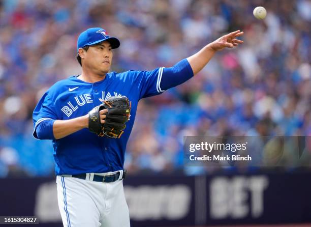 Hyun Jin Ryu of Toronto Blue Jays throws a ball to first base against the Chicago Cubs during the fifth inning in their MLB game at the Rogers Centre...