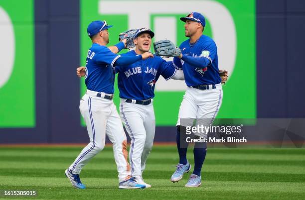 Daulton Varsho, Whit Merrifield, and George Springer of the Toronto Blue Jays celebrate defeating the Chicago Cubs in their MLB game at the Rogers...