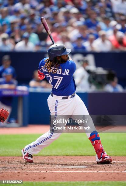 Vladimir Guerrero Jr. #27 of Toronto Blue Jays swings against the Chicago Cubs during the fifth inning in their MLB game at the Rogers Centre on...