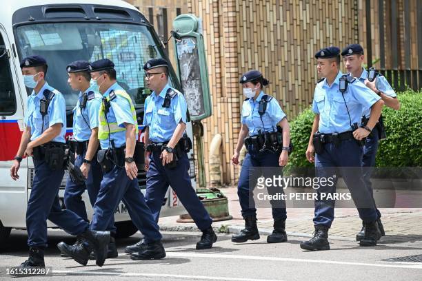 Police are seen at Tin Shui Wai division police station where Tang Kai-yin, the last one of the "The Hong Kong 12" to be released from prison,...