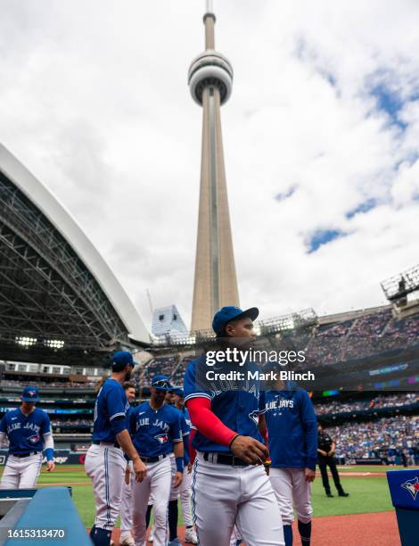 Santiago Espinal of Toronto Blue Jays walks to the dugout before playing the Chicago Cubs in their MLB game at the Rogers Centre on August 13, 2023...