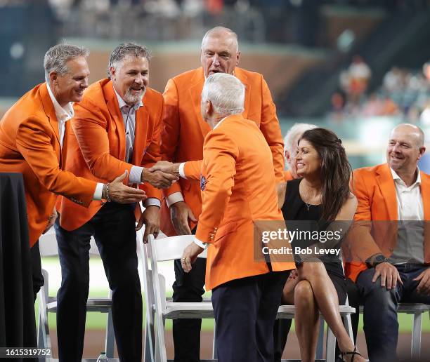 Bill Brown shakes hands with Craig Biggio, Lance Berkman and Terry Puhl as he is inducted into the Houston Astro Hall of Fame at Minute Maid Park on...