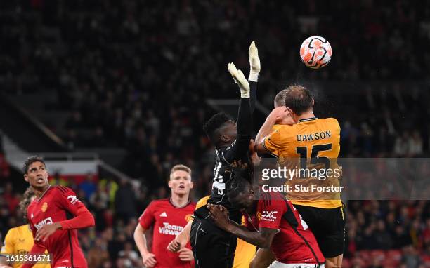 Manchester United goalkeeper Andre Onana challenges Wolves defender Craig Dawson and Sasa Kalajdzic which goes to VAR for a penalty check during the...
