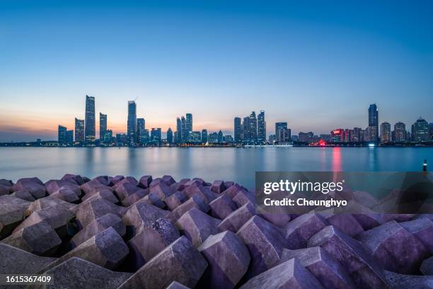 qingdao city skyline at dusk - shandong province photos et images de collection