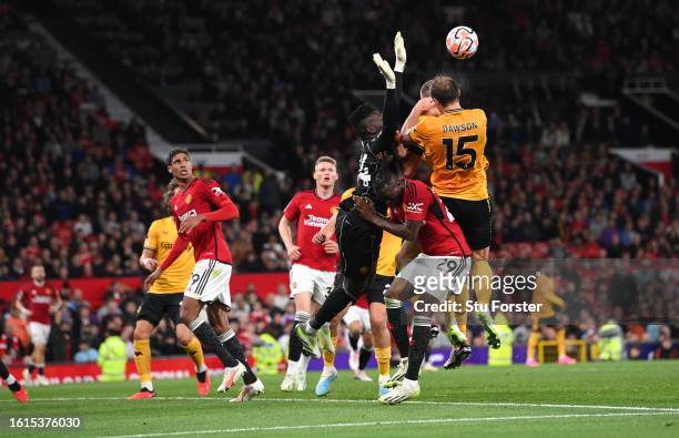 Manchester United goalkeeper Andre Onana challenges Wolves defender Craig Dawson and Sasa Kalajdzic which goes to VAR for a penalty check during the...