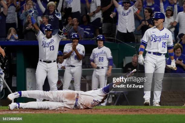 Bobby Witt Jr. #7 of the Kansas City Royals slides across home plate for an inside-the-park home run in the fifth inning against the Seattle Mariners...