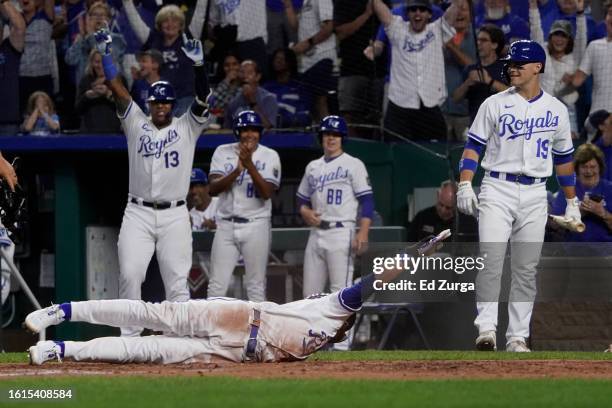 Bobby Witt Jr. #7 of the Kansas City Royals slides across home plate for an inside-the-park home run in the fifth inning against the Seattle Mariners...