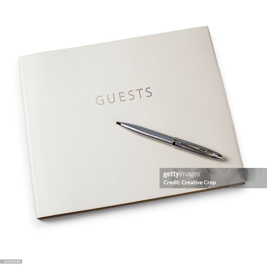Closed guest book and pen