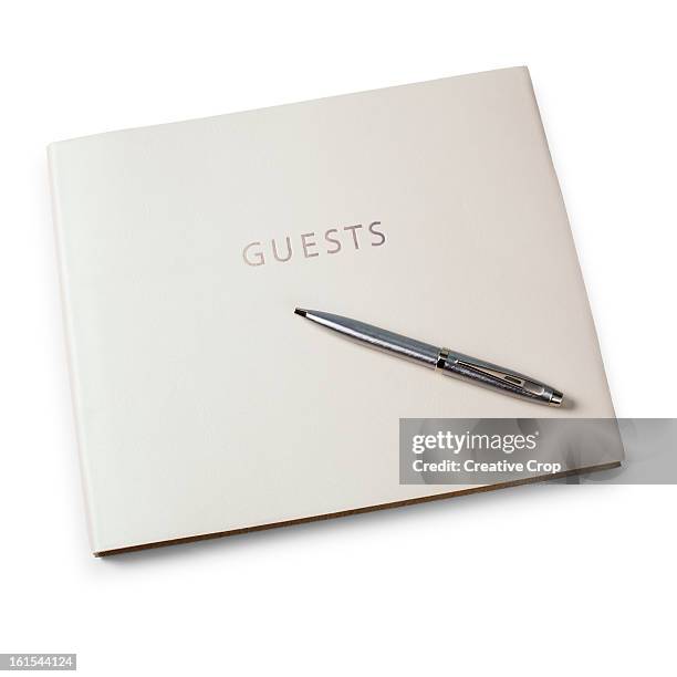 closed guest book and pen - gastenboek stockfoto's en -beelden