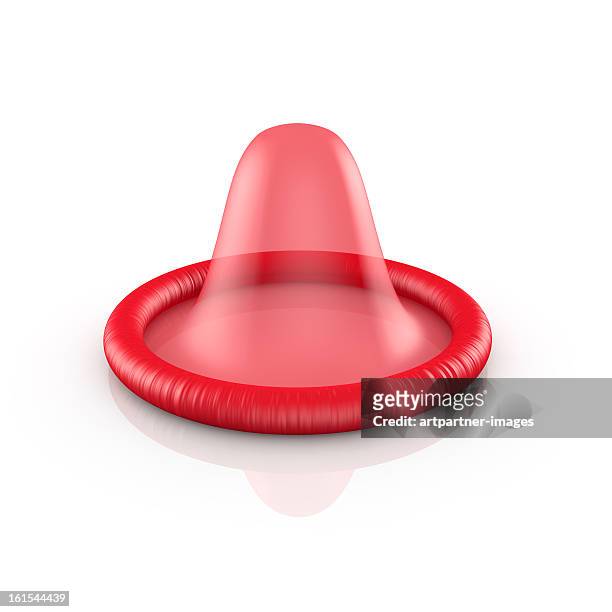 a red condom on a white background - condoms imagens e fotografias de stock