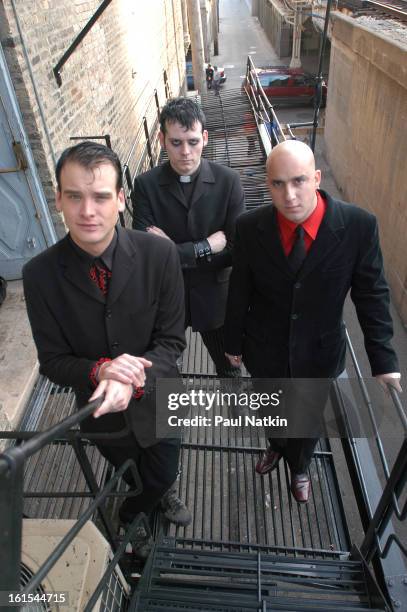 Portrait of American punk band Alkaline Trio as they pose on a fire escape, Chicago, Illinois, October 29, 2003. Pictured are, from left, guitarist...