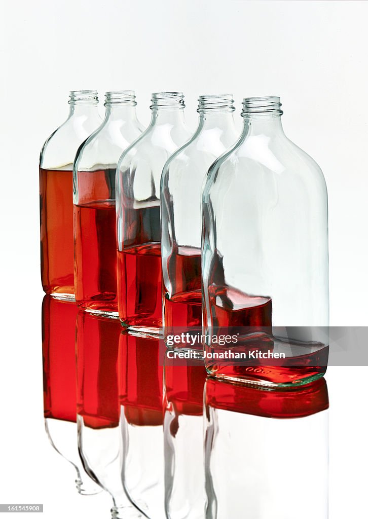 Stack of bottles with red liquid