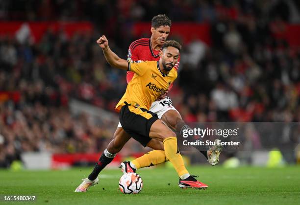 Matheus Cunha of Wolverhampton Wanderers is fouled by Raphael Varane of Manchester United during the Premier League match between Manchester United...