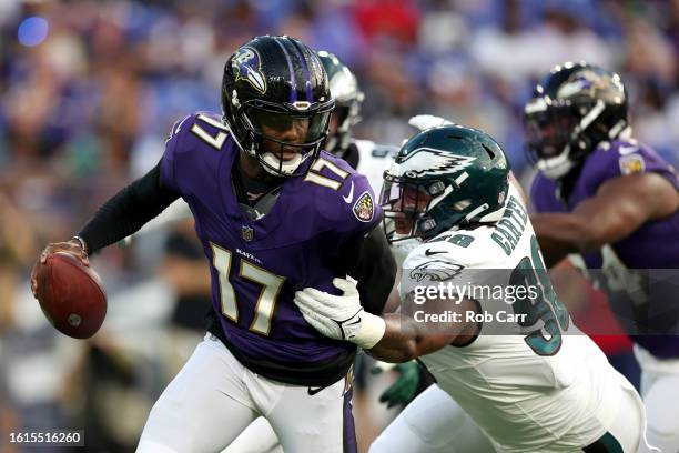 Quarterback Josh Johnson of the Baltimore Ravens is tackled by defensive tackle Jalen Carter of the Philadelphia Eagles during the first half of a...