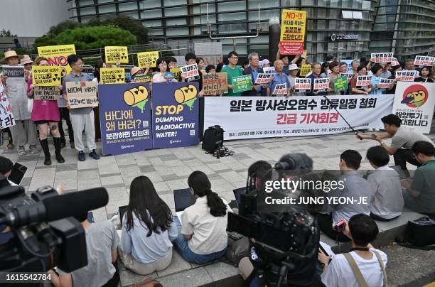 South Korean protesters hold a banner reading "Withdraw the release schedule of Japan's radioactive contaminated water!" during a rally against the...