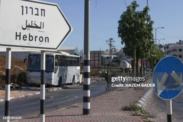 Israeli security forces man a checkpoint at the closed-off southern entrance of Hebron city in the occupied West Bank, on August 22 near the Israeli...