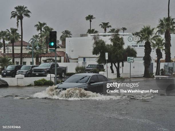 August 20: A car drives through the flooded streets of downtown Palm Springs, California on August 20, 2023. Southern California is under a tropical...