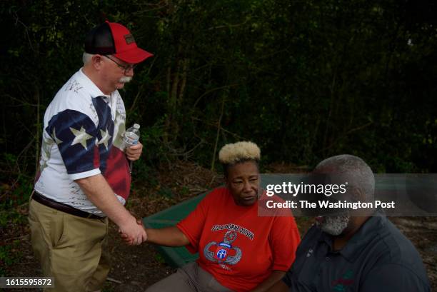 Ben Hancock, of Jasper, and Wretha Thomas, of Houston, speak with Anderson Land, the mayor of Jasper, as the family and friends of James Byrd Jr....
