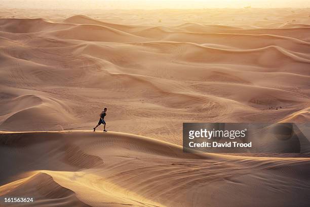 man running in sand dunes - endurance run stock pictures, royalty-free photos & images