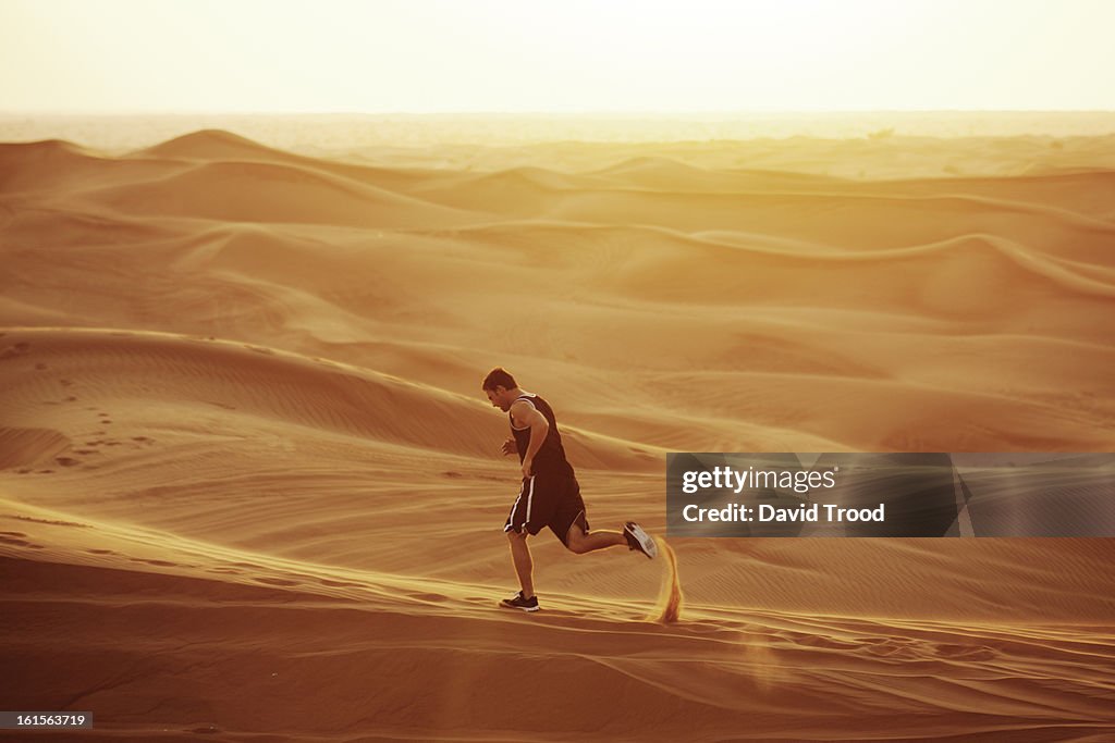 Man running in sand dunes