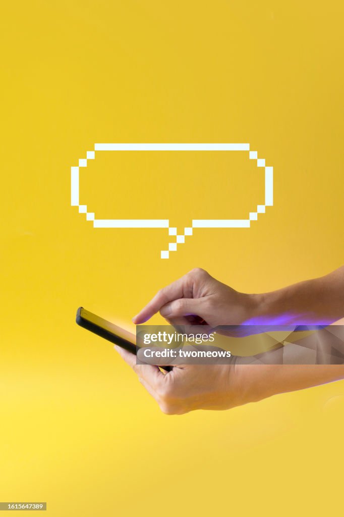 Chatting with AI technology chatbot with mobile phone - stock photo.