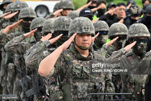 South Korean soldiers salute after an anti-terror drill on the sidelines of the annual Ulchi Freedom Shield joint military exercise between South...