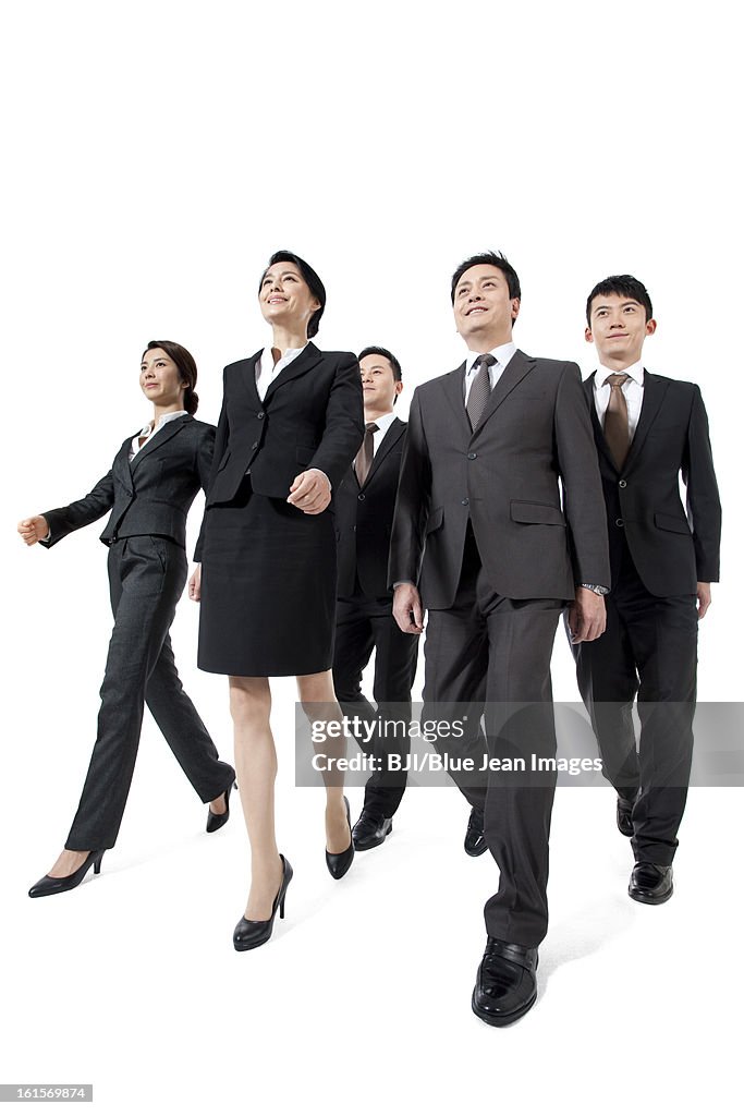 Confident business team walking forward